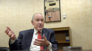 Bob Becker, a senior vice president with St. John Properties, is pictured in his office. Behind him is a photogeraph of him finishing a marathon. He has worked his way up the ranks from driver and grass cutter to senior vice president, while having multiple sclerosis. (Algerina Perna / Baltimore Sun)
